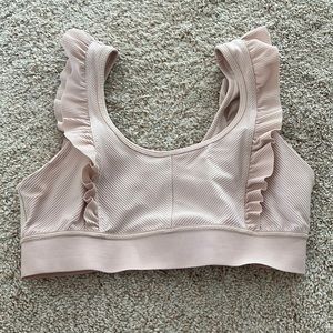 Pale pink sports bra with ruffle sleeves from Free People